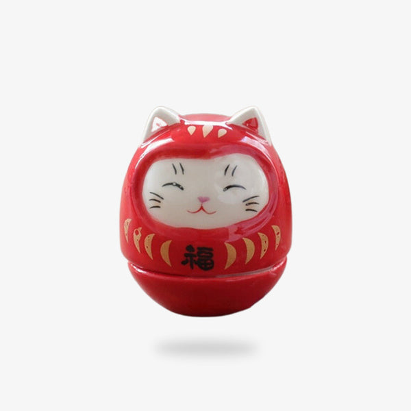 Cet objet de décoration japonaise est un chat maneki neko kawaii de couleur rouge. C'est un porte bonheur japonais en matière céramique