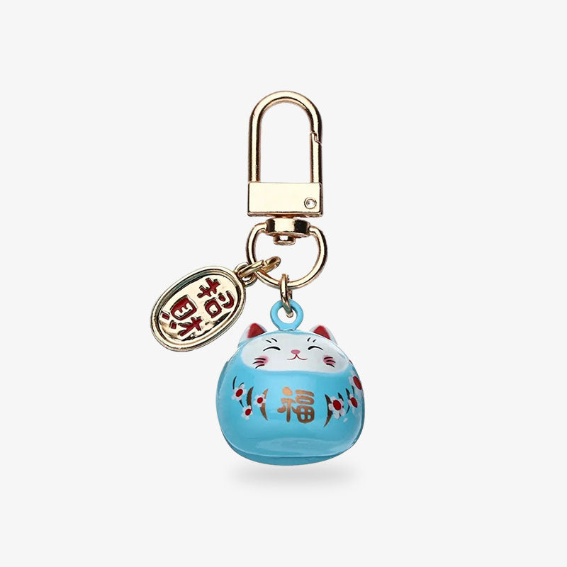 Ce porte-clés chat de la fortune maneki est de couleur bleu ciel. La piecette est dorée