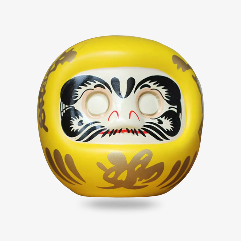 Poupée daruma jaune japonaise vue de face