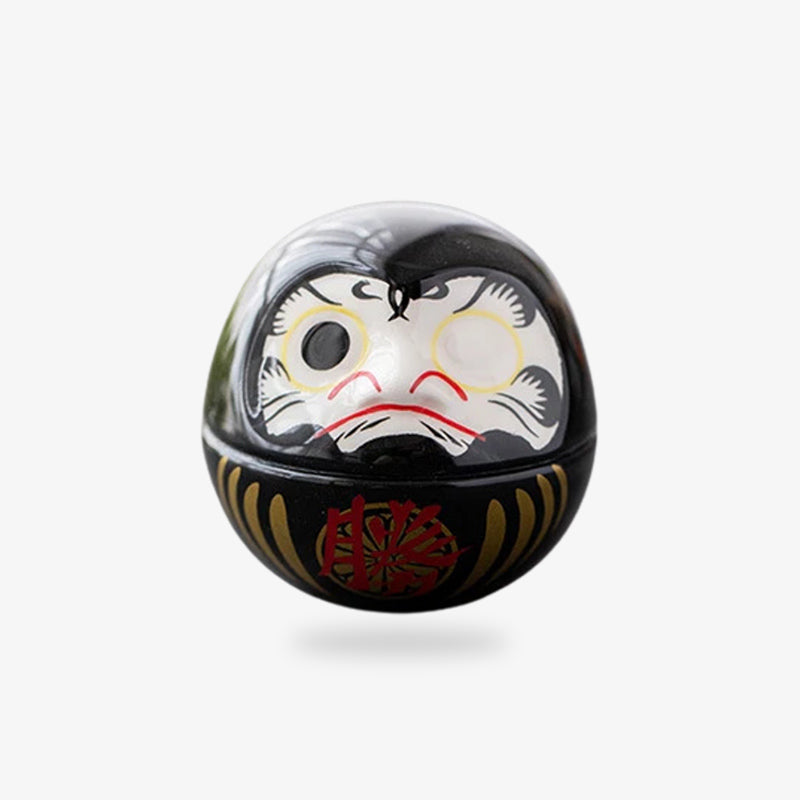 Poupée daruma noire en céramique, symbole japonais de force et de persévérance