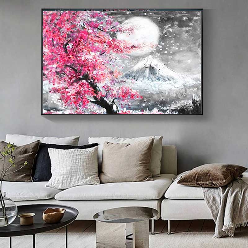 Ce tableau cerisier sakura japon est sur un mur dans un salon avec un fauteuil. Le tableau japonais représente le mont fuji