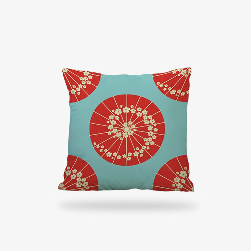 Une housse coussin style japonais de couleur rose avec des motifs d'ombrelles japonaises de couleur rouge