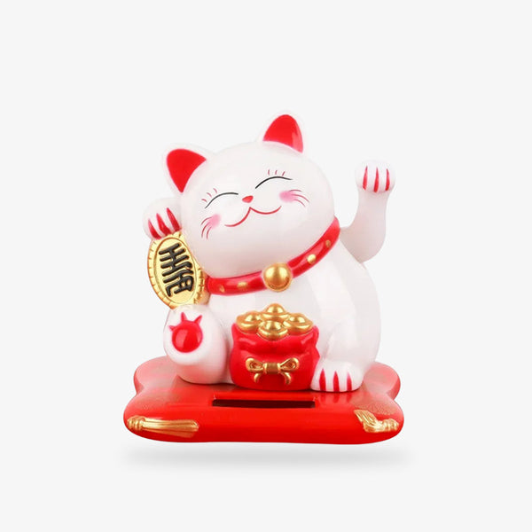 Le Maneki Neko Cat est un chat japonais porte-bonheur. C'est une petite statuette de chat de couleur blanche et rouge qui tient une pièce de monnaie koban dans la patte. Sa patte gauche est levée et bouge pour attirer les clients. C'est un chat Neko Maneki qui symbolise, la chante, la prospérité et la bonne fortune