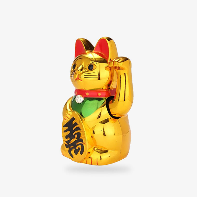 Le chat japonais porte-bonheur Maneki Neji Dore a sa patte gauche levée