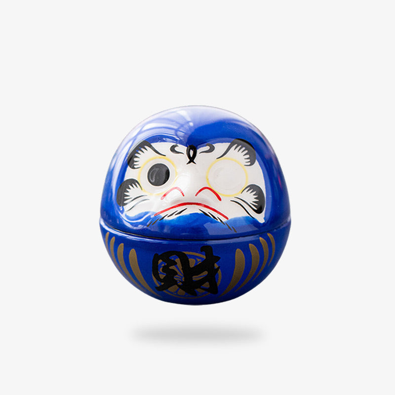 Daruma bleu peint avec un œil noir et des kanji