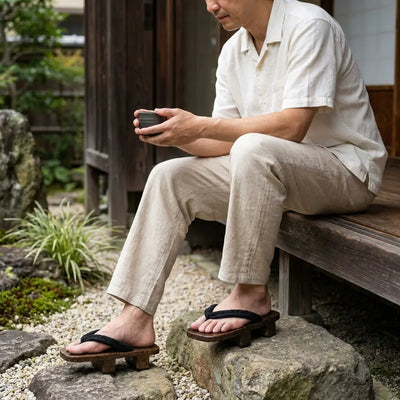 Geta portées avec des chaussettes tabi blanches dans un jardin japonais