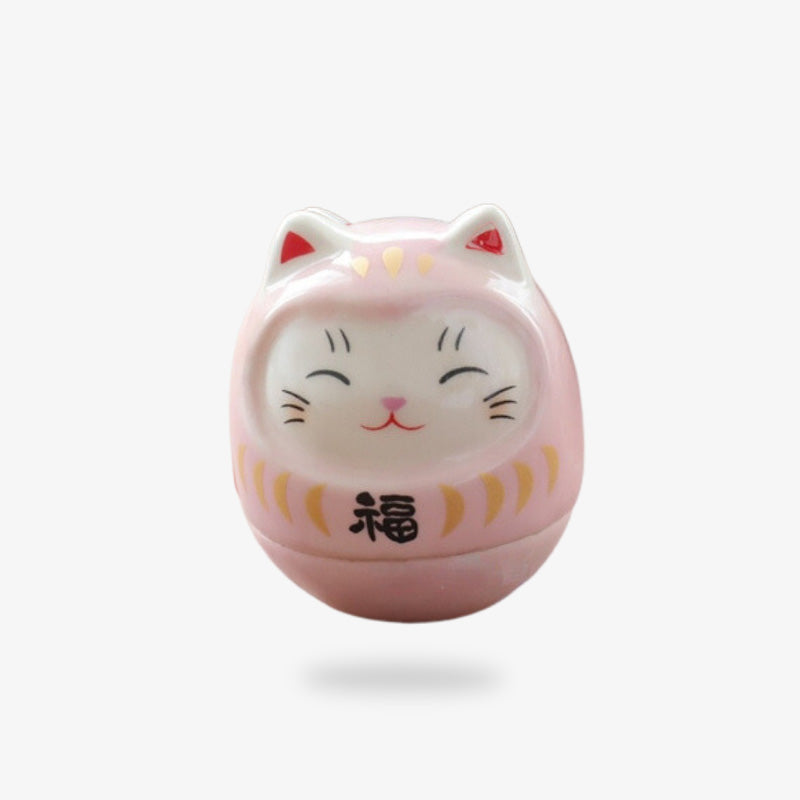 Un porte bonheur japonais maneki neko rose fabriqué en matière céramique et en forme de tête de chat mignon