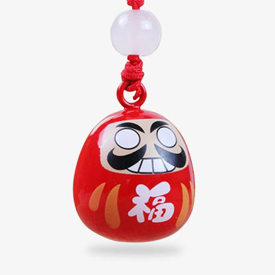 Ce porte-clés poupée Daruma est un symbole de résilience et de détermination, un porte-bonheur japonais populaire pour se motiver