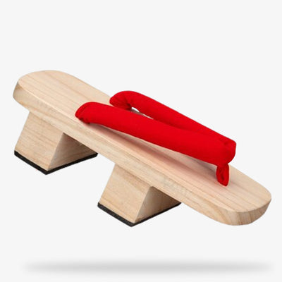 La chaussure japonaise bois s'appelle une sandale Geta. C'est une tongue japonaise avec une plateforme et une lanière rouge
