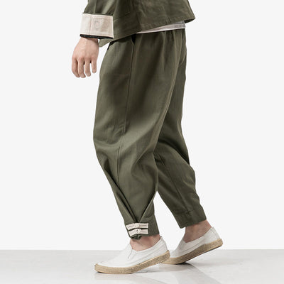 Un homme porte un pantalon de ninja avec des chaussures chaussons blancs de style japonais Shinobi